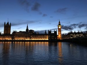 An evening photo of the House of Commons, from across the Thames
