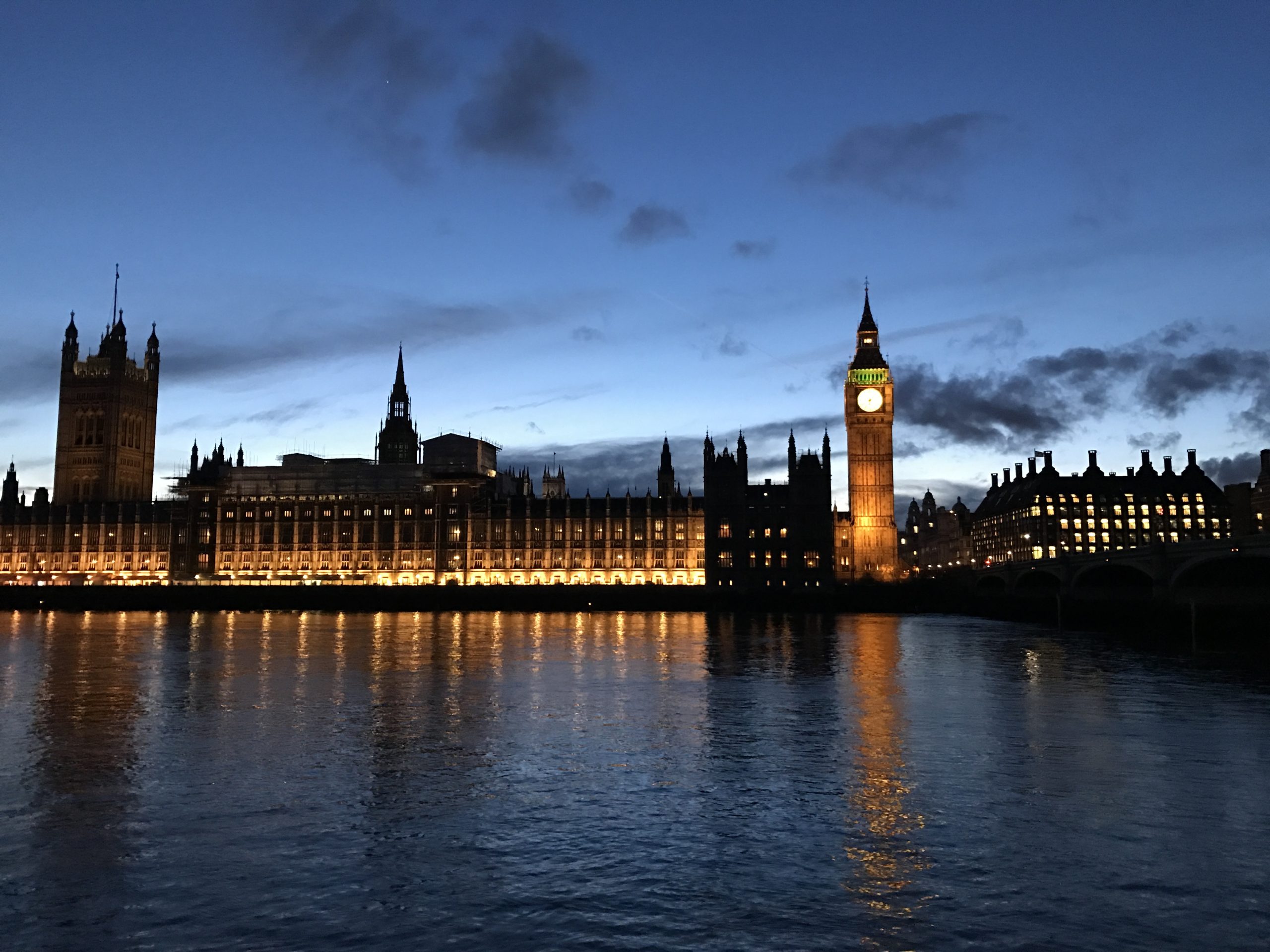 An evening photo of the House of Commons, from across the Thames
