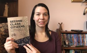 Stef Benstead with a copy her book, Second Class Citizens, which looks at the way the UK has breached disabled people's human rights