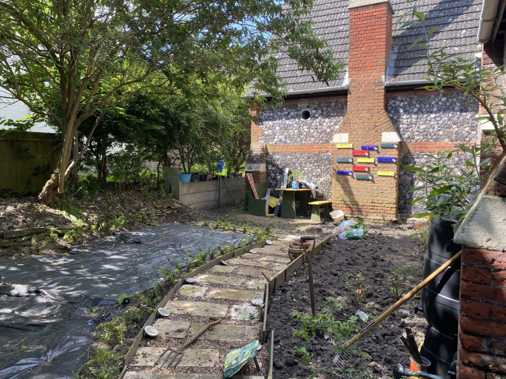 Kirkley Pantry Community Garden: work in progress to redesign an area. A path is laid, and ground is being cleared