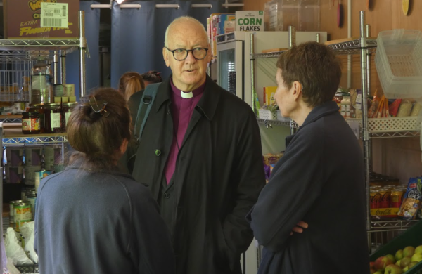 The Bishop of Leeds chats to a volunteer, inside InterAct Pantry