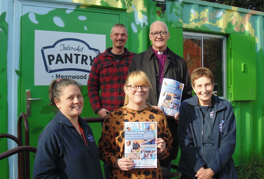 A posed group shot, including the Bishop of Leeds at InterAct Pantry