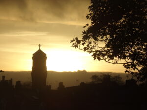 A church tower with sunset behind