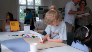 A young girl doing crafts at a table