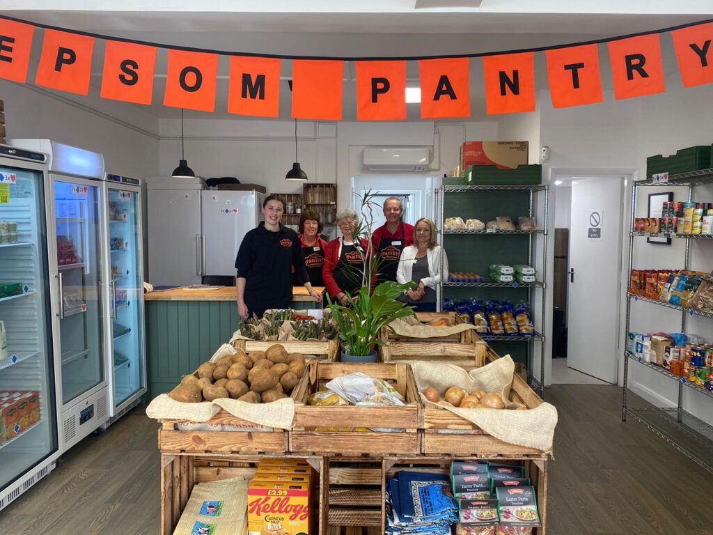 Volunteers in a Pantry, with "Epsom Pantry" bunting above them