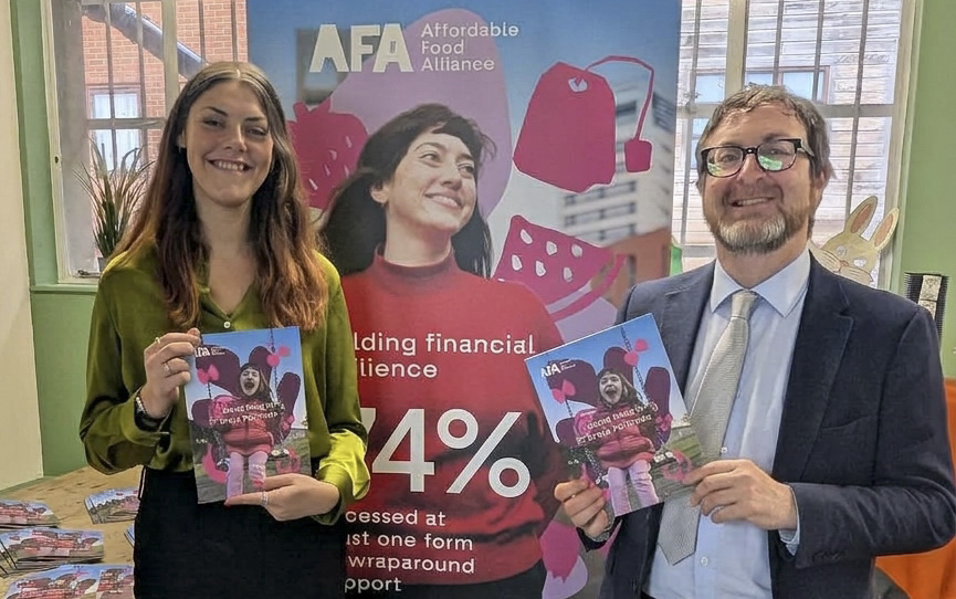 Ellie and Liam, holding copies of the Good Food In Every Postcode report