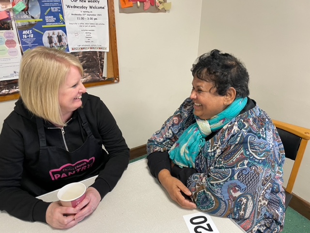 Two women chatting and smiling