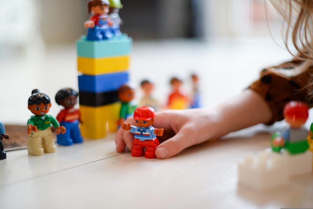 A child playing with toy Duplo figures