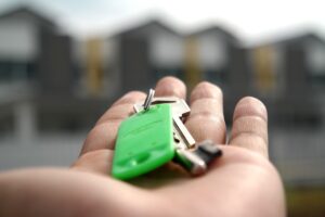 A stock image of a hand holding a set of house keys