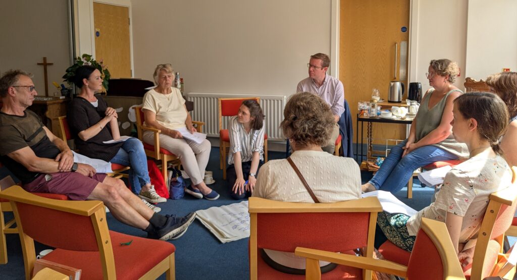 People sitting in chairs in a group discussion circle